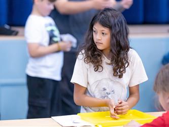 student at table with crafts