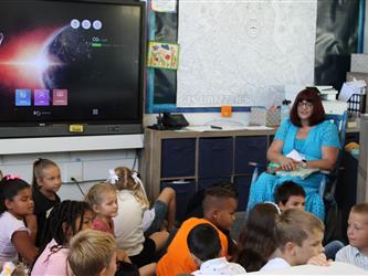 students listening to teacher in class