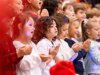 students excitedly performing for event