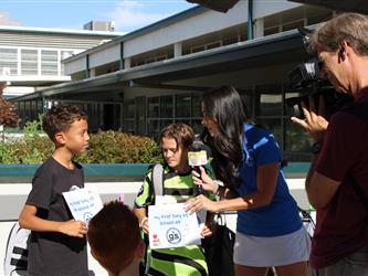 news team speaking with students
