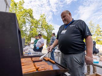man grilling hot dogs 