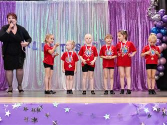 performers walking on stage to receive awards