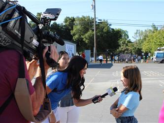 news team speaking with students