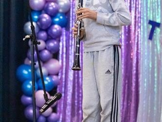 student playing flute on stage