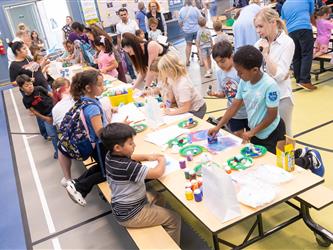 students at table with crafts