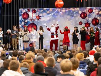 students performing on stage with santa