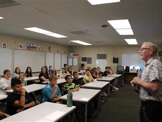 students listening to teacher in class