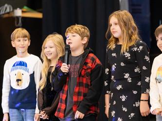 students performing on stage