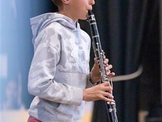 student playing flute on stage