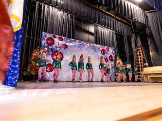 students excitedly performing for event