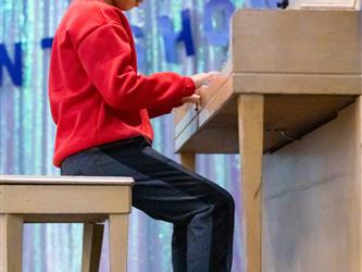 student playing piano on stage