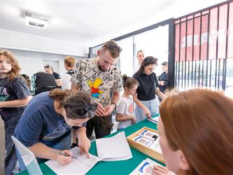 students signing up at table