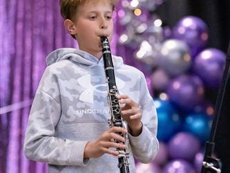 student playing flute on stage