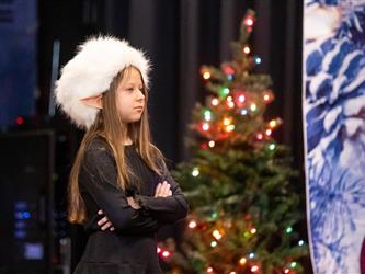 students performing on stage with santa