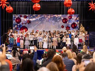 wide angle of students on stage in front of crowd
