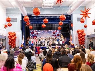 wide angle of students on stage in front of crowd