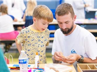 parent making craft with child 