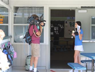 news team speaking with students