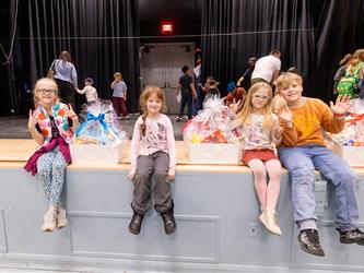 students sitting on stage