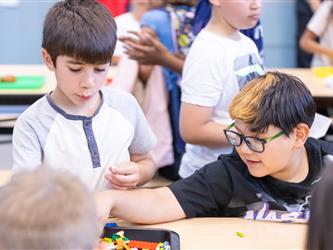 students at table with crafts