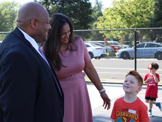 students posing with principal and superintendent