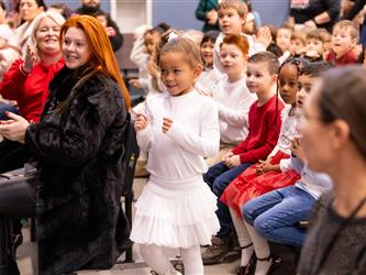 students excitedly performing for event