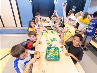 students at table with crafts