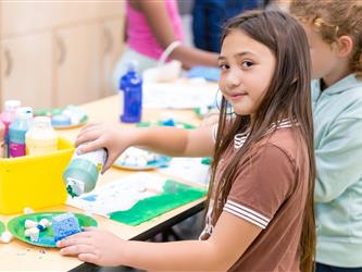 student displaying craft