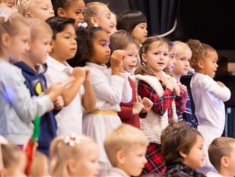 students excitedly performing for event