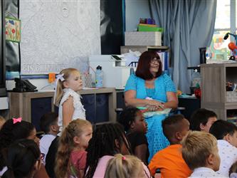 teacher assisting student with materials 