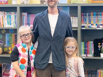 gis principal posing with two kids 