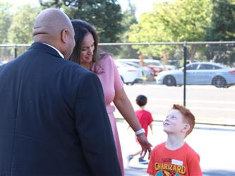 students posing with principal and superintendent
