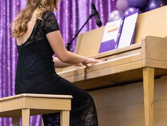 student playing piano on stage