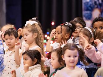 students excitedly performing for event