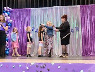performers walking on stage to receive awards