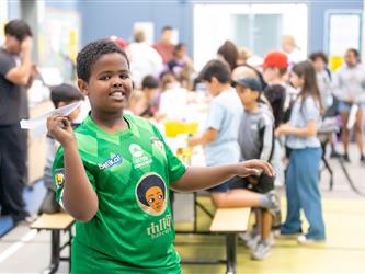 student throwing paper plane 