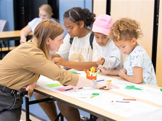 staff helping students with crafts