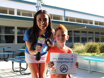 news team posing with student 