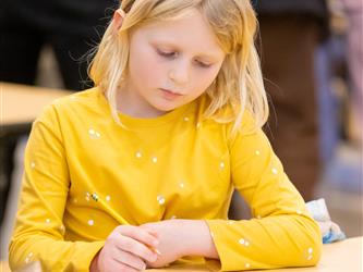 student writing onto page