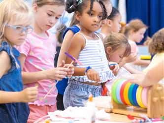 students lined at table for crafts
