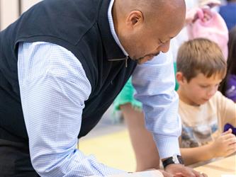superintendent making crafts with students 