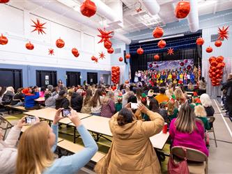 parent taking photo of their child performing
