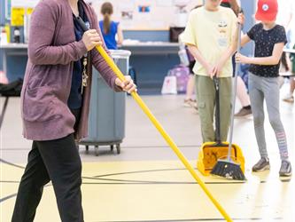 staff sweeping floors 