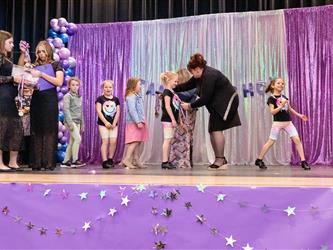 performers walking on stage to receive awards