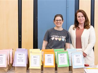women smiling at booth