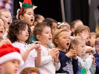 students excitedly performing for event