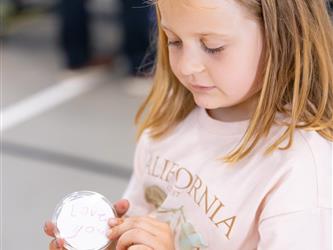 child showing off creation 