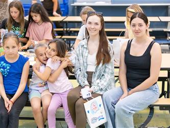 family seated on bleachers 