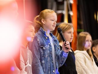 students performing on stage