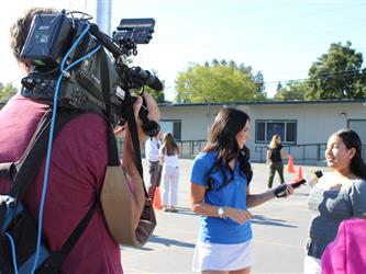 news team speaking with students